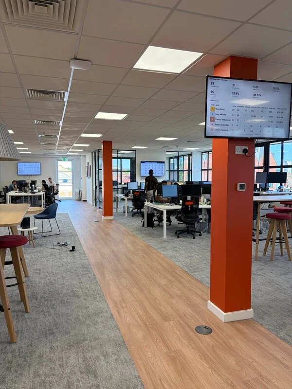 Structural office pillars wrapped in custom orange architectural vinyl by FASTSIGNS St Albans.